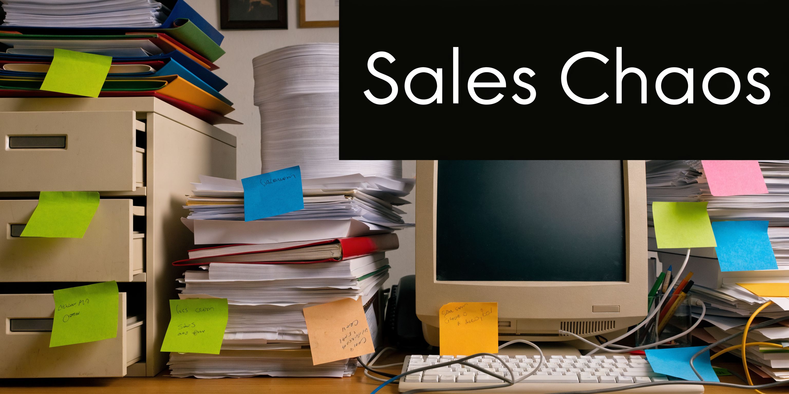 An office desk cluttered with overflowing paperwork, files, and sticky notes, representing disorganized and chaotic sales operations.